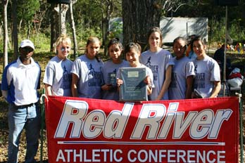 Northwood's women's cross country team with their conference trophy and RRAC Coach of the Year Nat Amare